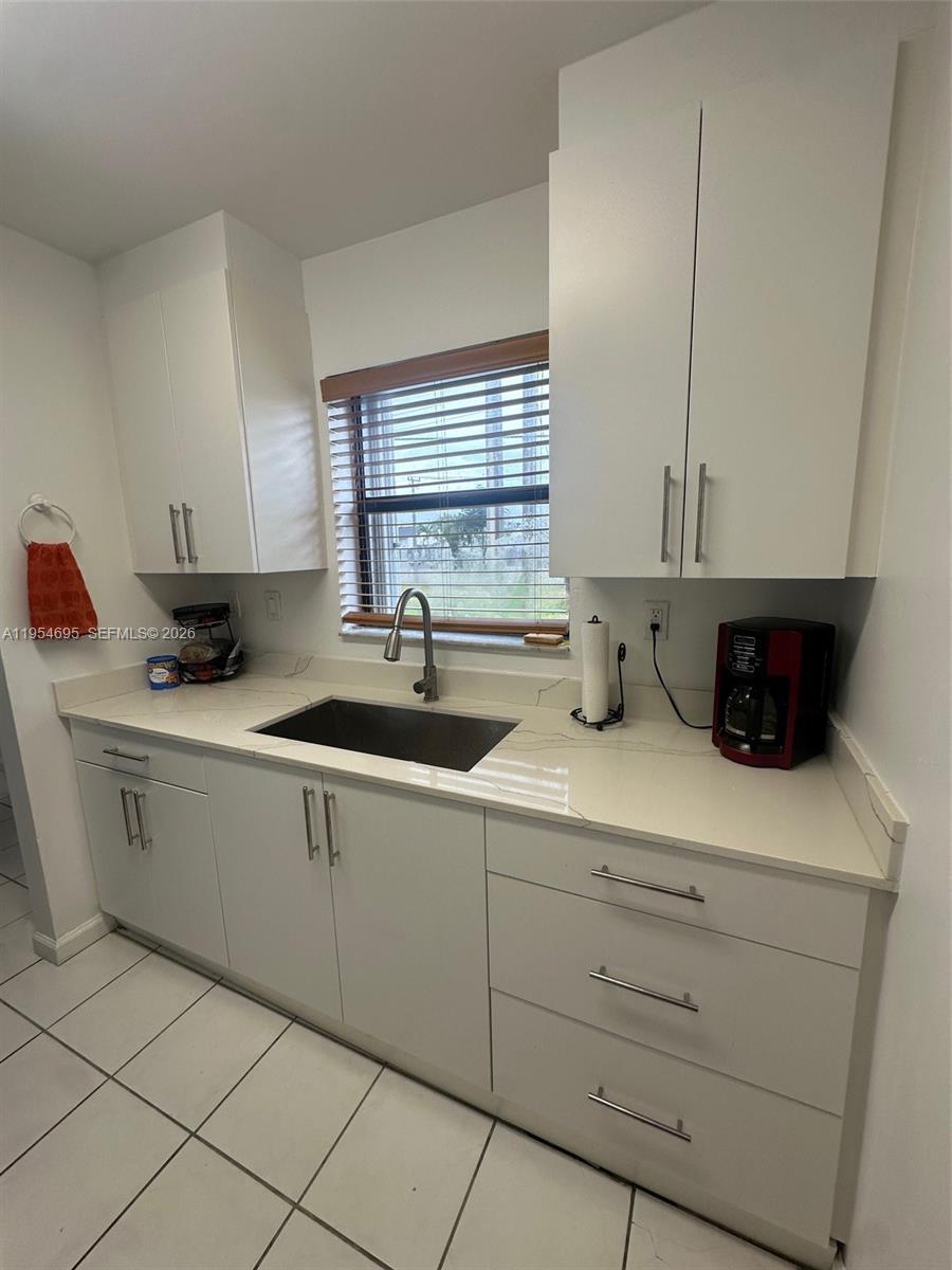 13671 Southwest 62nd Street, Unit 2011 Miami, FL 33183 - Photo 5 of 24 a kitchen with sink cabinets and window