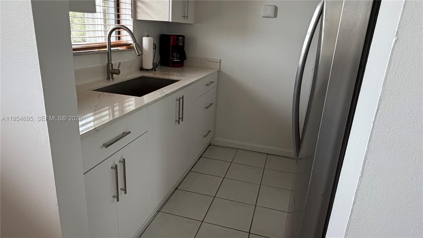 13671 Southwest 62nd Street, Unit 2011 Miami, FL 33183 - Photo 6 of 20 a kitchen with a sink and cabinets