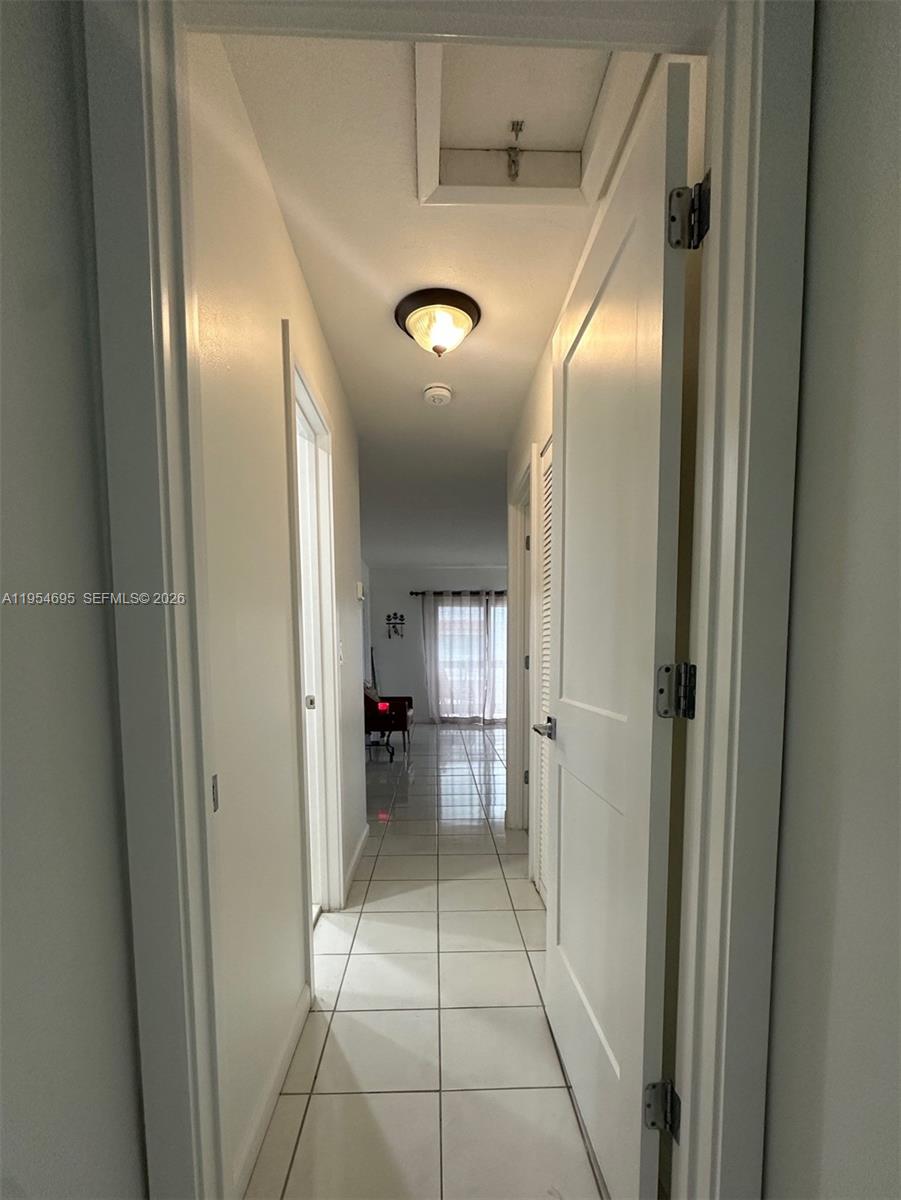 13671 Southwest 62nd Street, Unit 2011 Miami, FL 33183 - Photo 8 of 24 a view of a hallway with a furniture and a livingroom