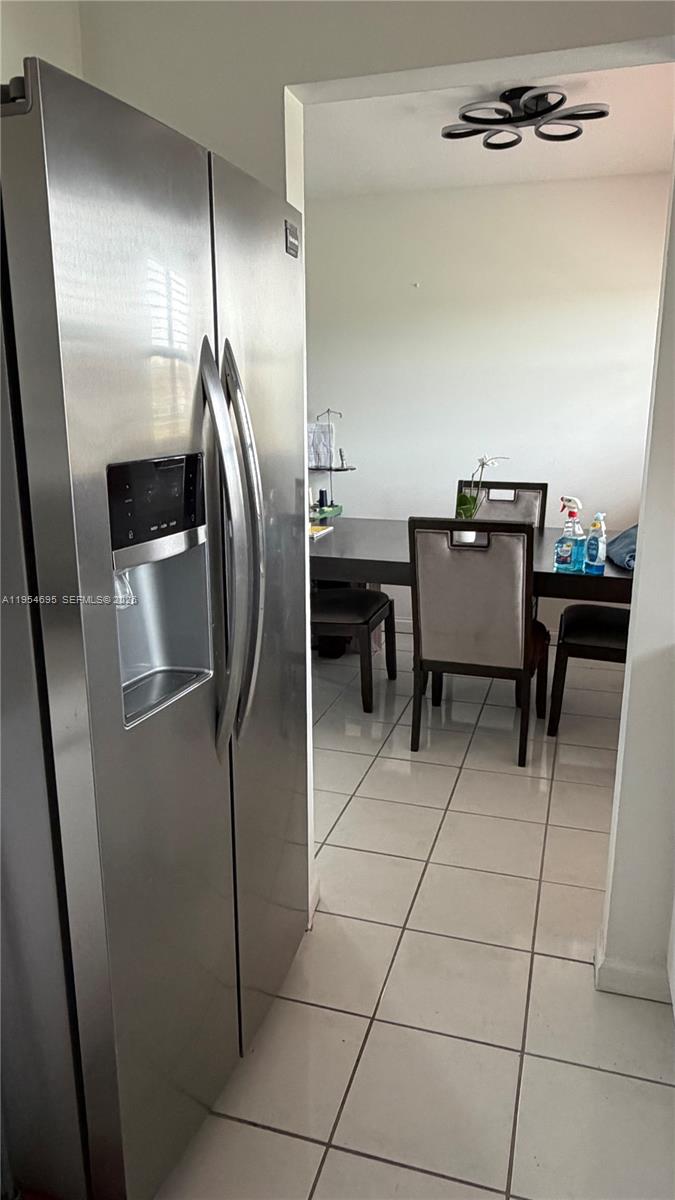 13671 Southwest 62nd Street, Unit 2011 Miami, FL 33183 - Photo 8 of 20 a room with stainless steel appliances kitchen island granite countertop furniture and a refrigerator
