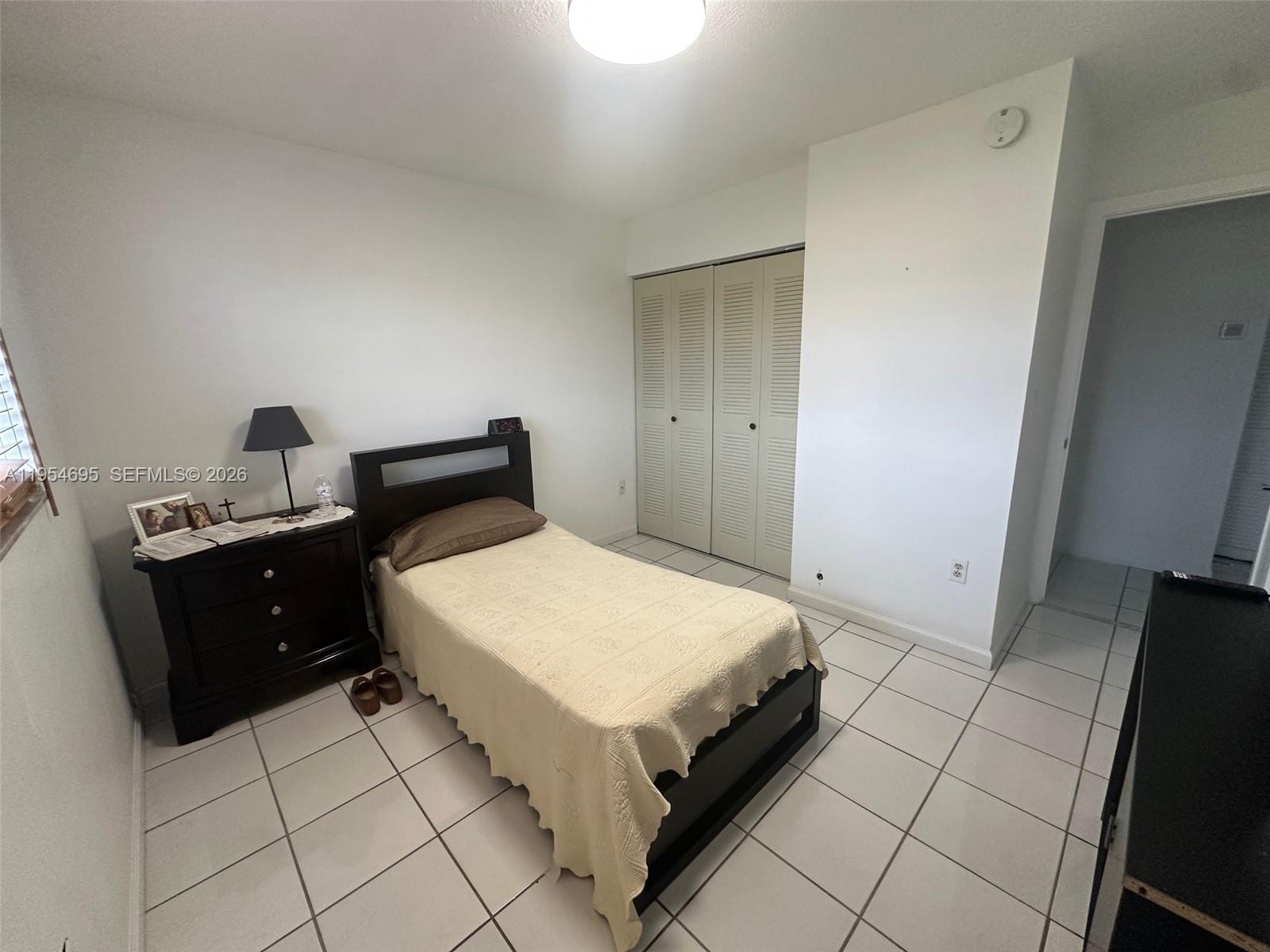 13671 Southwest 62nd Street, Unit 2011 Miami, FL 33183 - Photo 9 of 24 a bedroom with a bed and a dresser