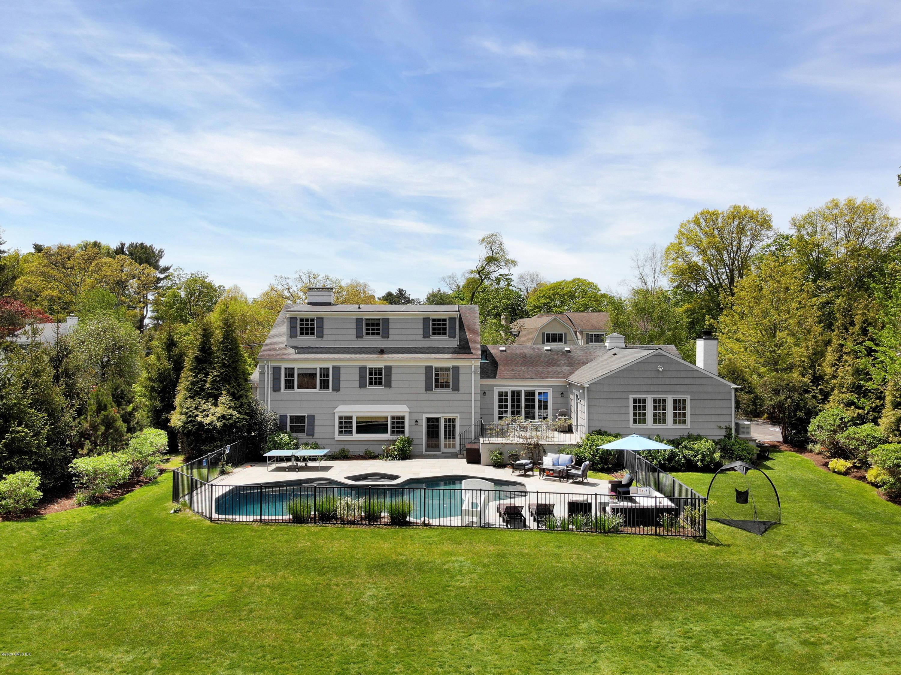 a aerial view of a house with swimming pool garden and patio