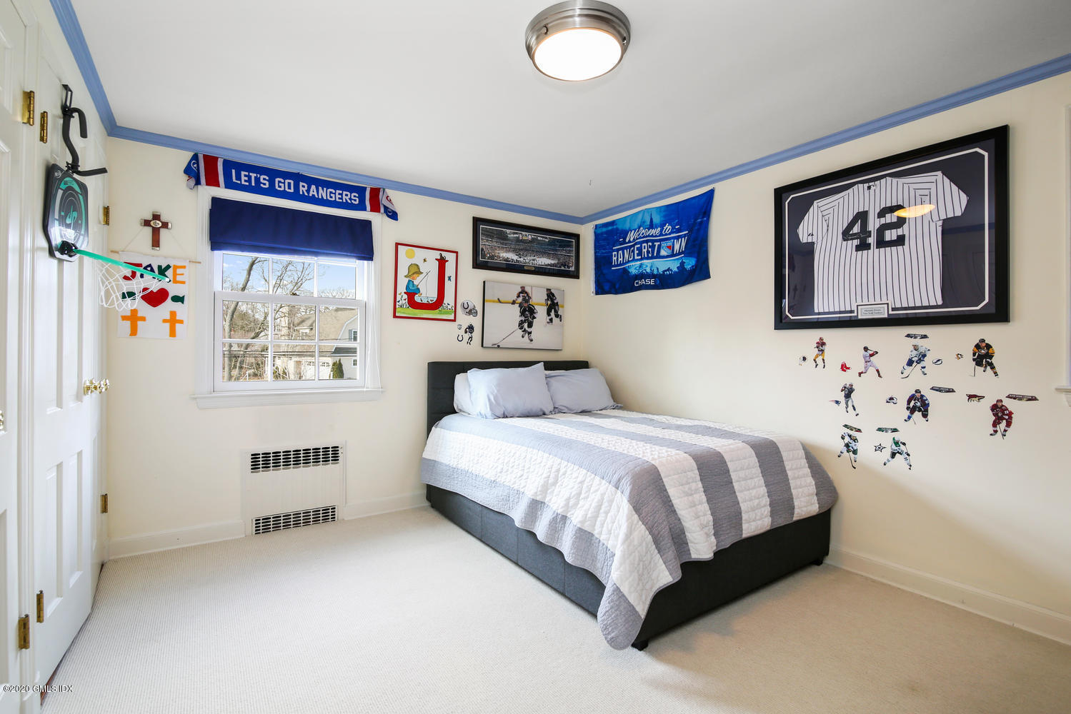 7 Highgate Road Riverside, CT 06878 - Photo 15 of 34 a bedroom with a bed and a book shelf