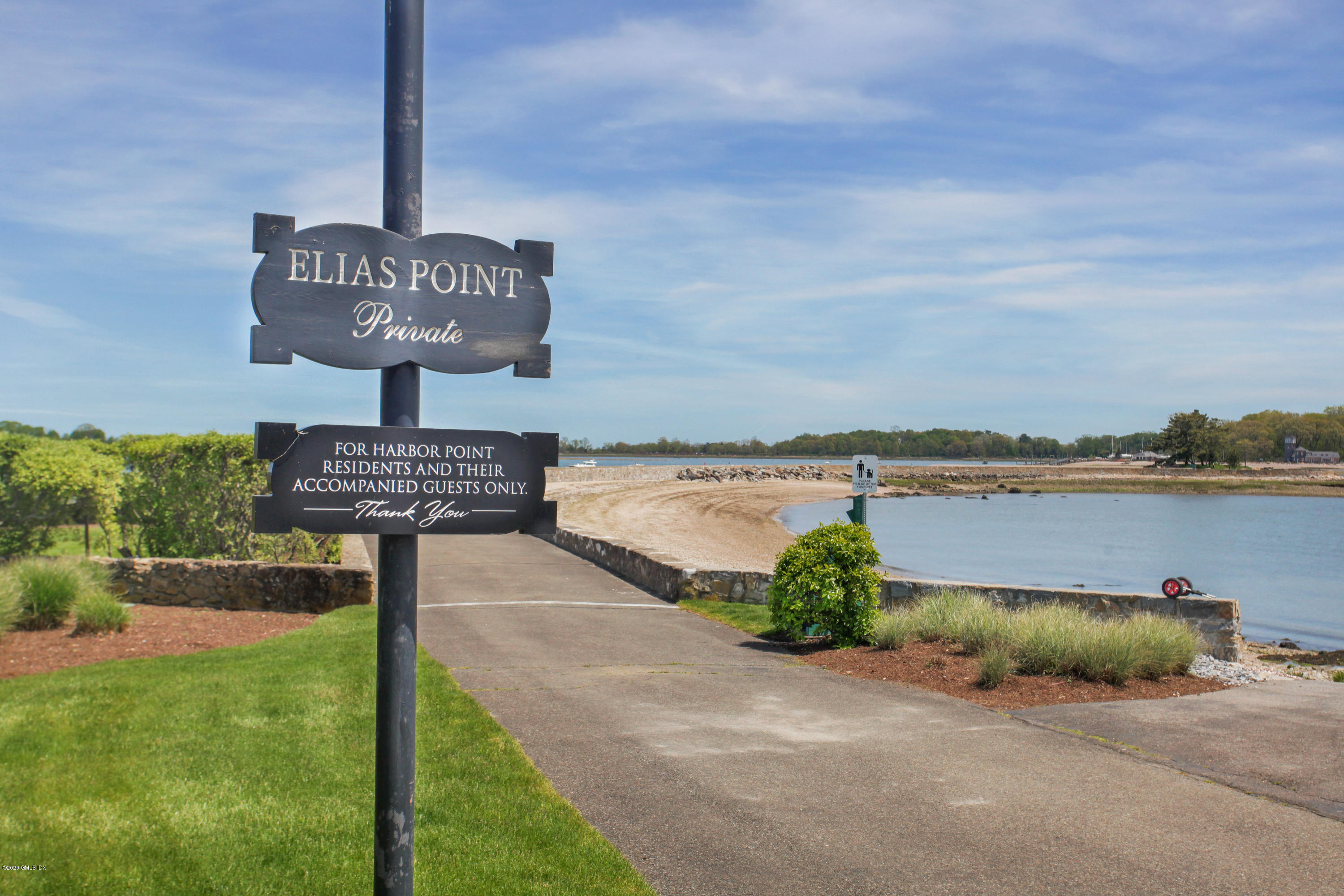 7 Highgate Road Riverside, CT 06878 - Photo 26 of 34 a street sign on a wall next to a road