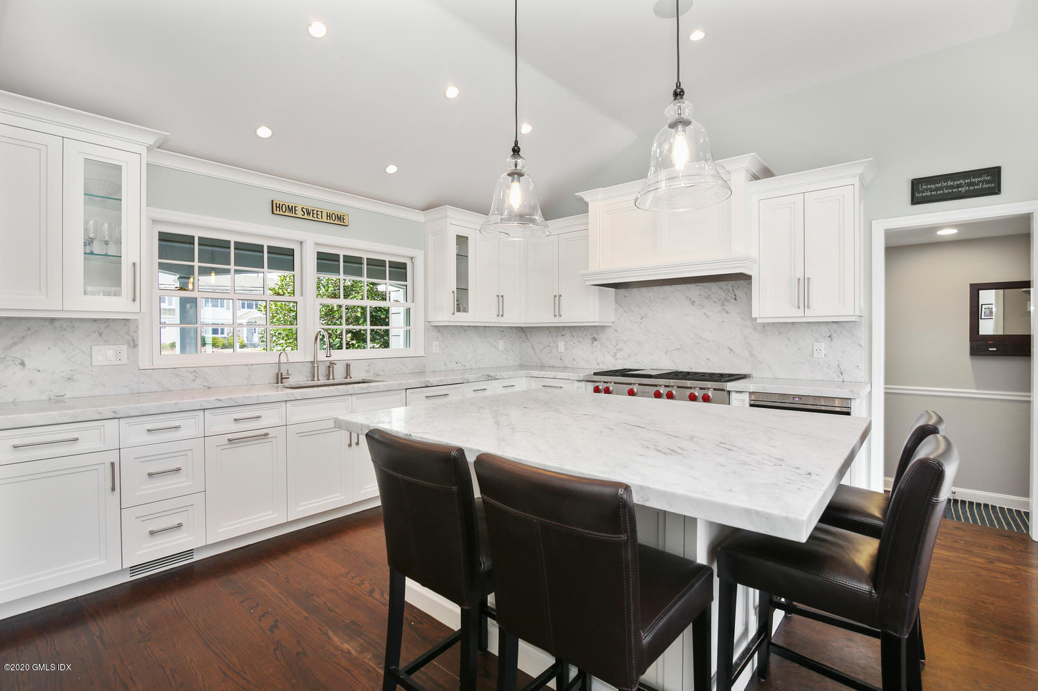 7 Highgate Road Riverside, CT 06878 - Photo 8 of 34 a kitchen with stainless steel appliances granite countertop a stove a table a sink refrigerator and cabinets