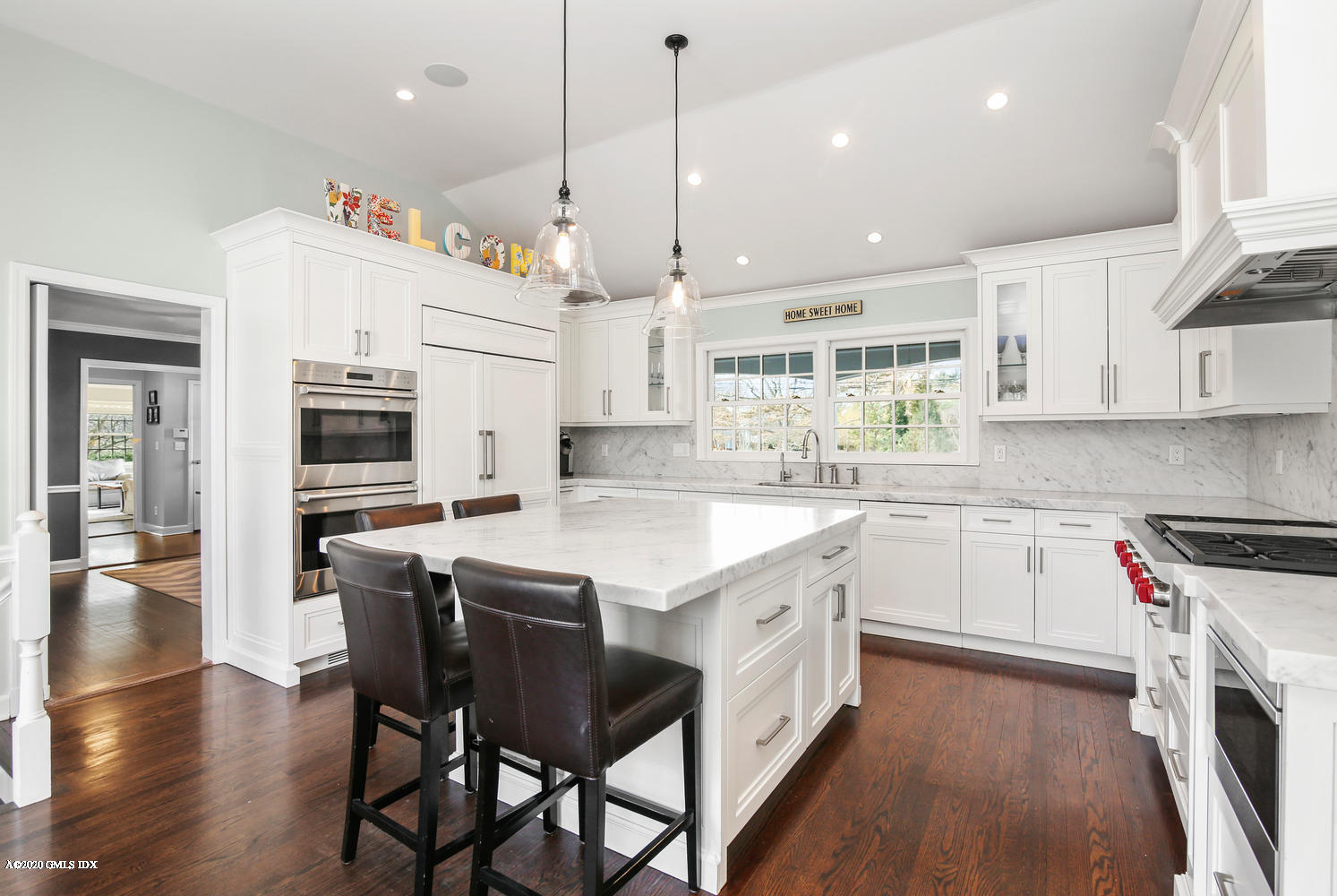 7 Highgate Road Riverside, CT 06878 - Photo 9 of 34 a kitchen with stainless steel appliances granite countertop a stove a sink dishwasher a refrigerator white cabinets and wooden floor