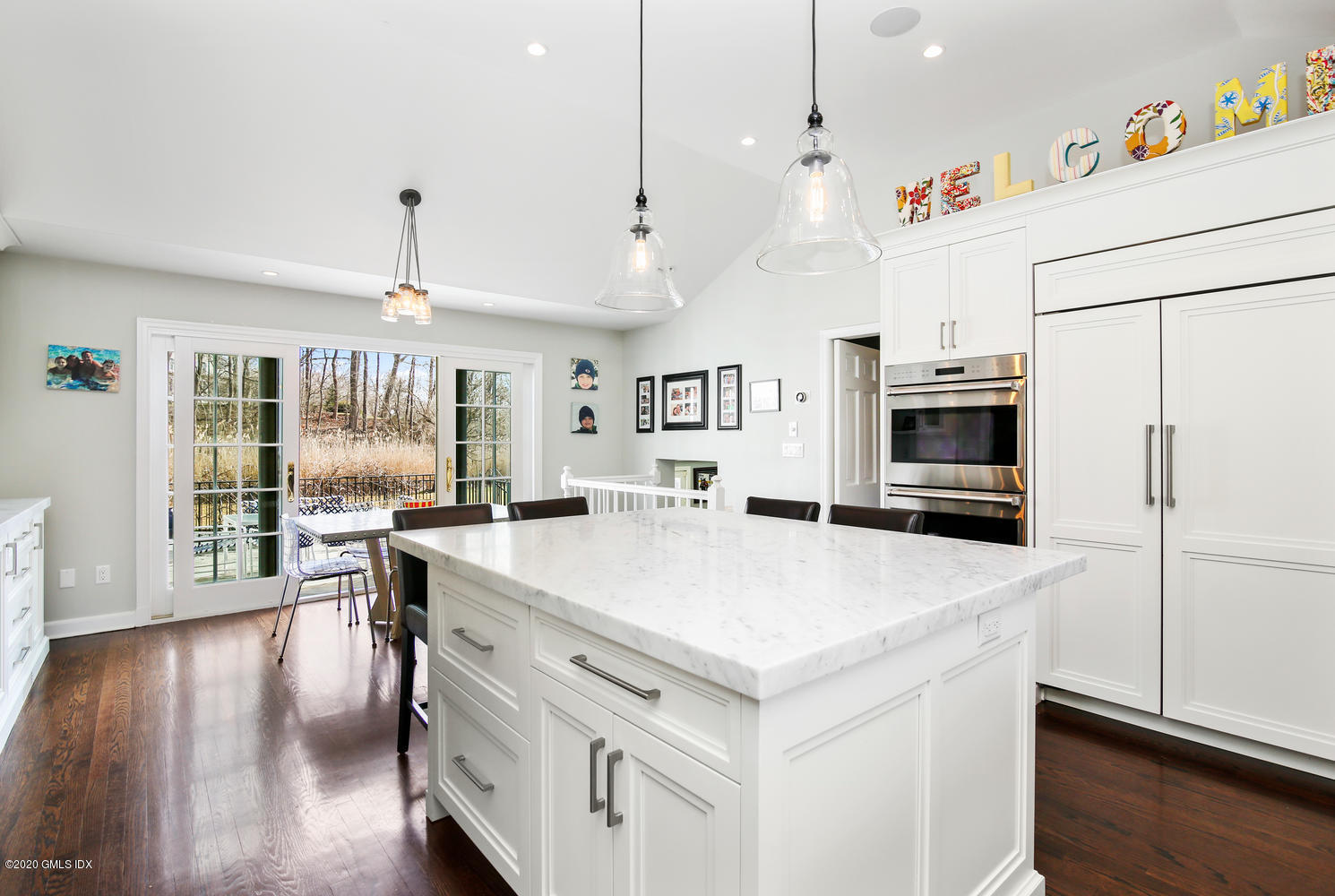 7 Highgate Road Riverside, CT 06878 - Photo 10 of 34 a large kitchen with kitchen island a stove a table and chairs in it