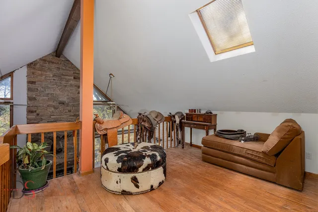 a bed sitting in a bedroom next to a chair