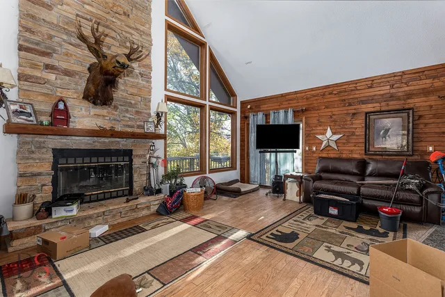 a living room with furniture a fireplace and a floor to ceiling window
