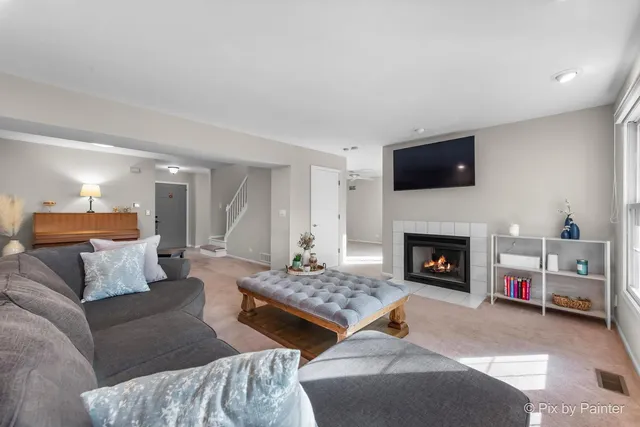 a living room with furniture and a fireplace