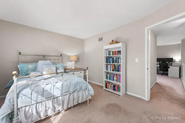 a bedroom with a bed and a book shelf