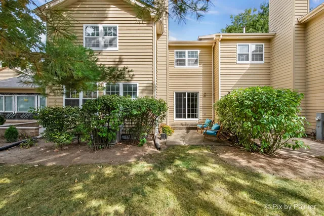 a view of a house with a yard and sitting area