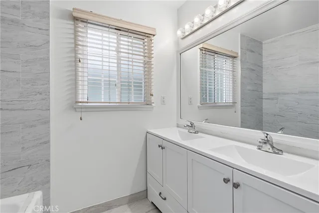 a bathroom with a sink and a window