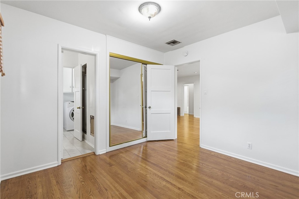 16753 Magnolia Boulevard Encino, CA 91436 - Photo 15 of 30 a view of an empty room with wooden floor and a bathroom
