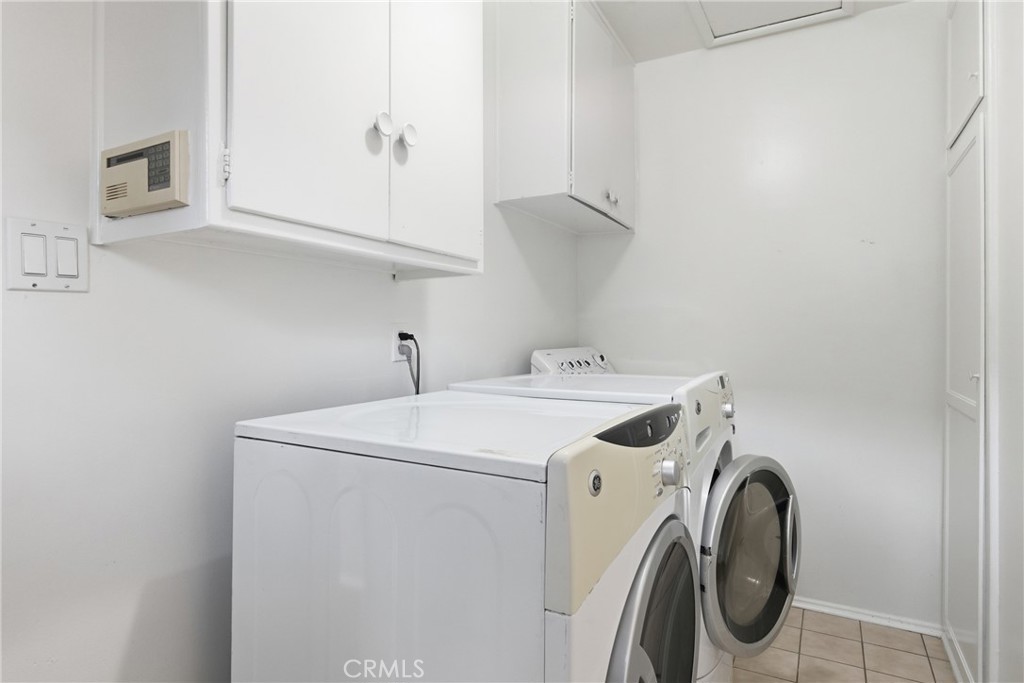 16753 Magnolia Boulevard Encino, CA 91436 - Photo 18 of 30 a utility room with dryer and washer