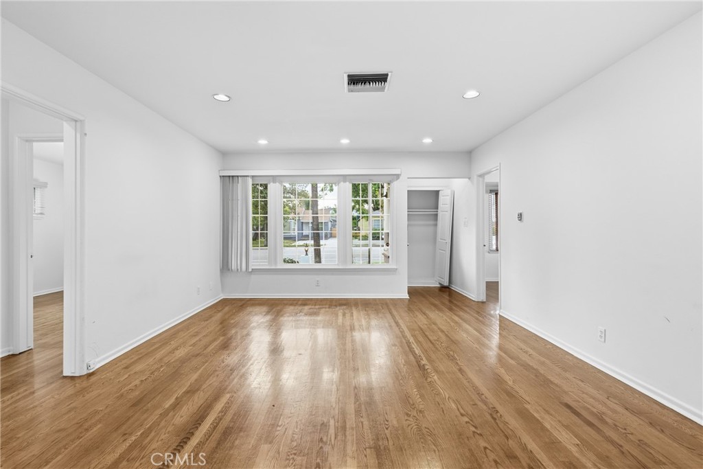 16753 Magnolia Boulevard Encino, CA 91436 - Photo 22 of 30 wooden floor in an empty room with a window