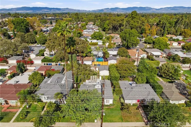 an aerial view of residential houses with outdoor space
