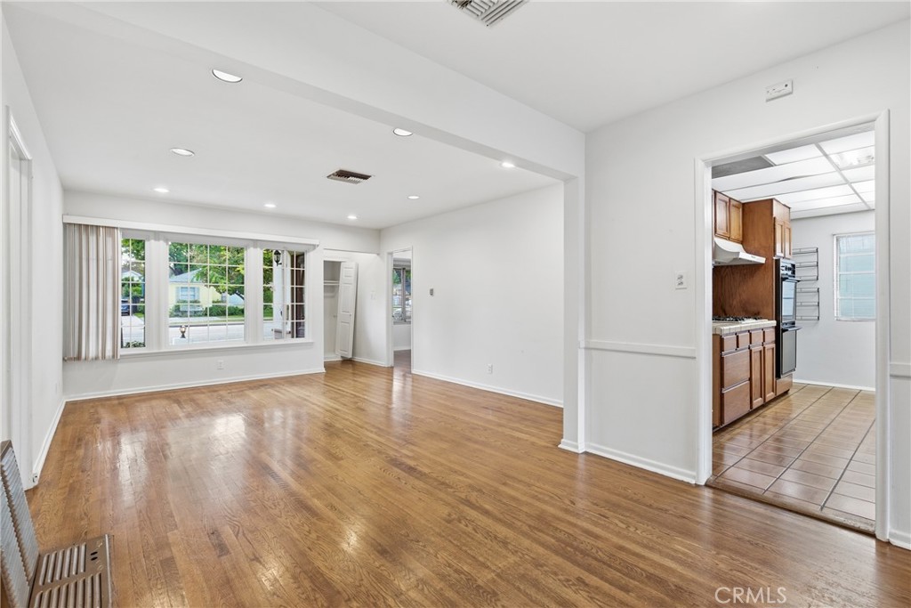 16753 Magnolia Boulevard Encino, CA 91436 - Photo 4 of 30 a view of an empty room with wooden floor and a window