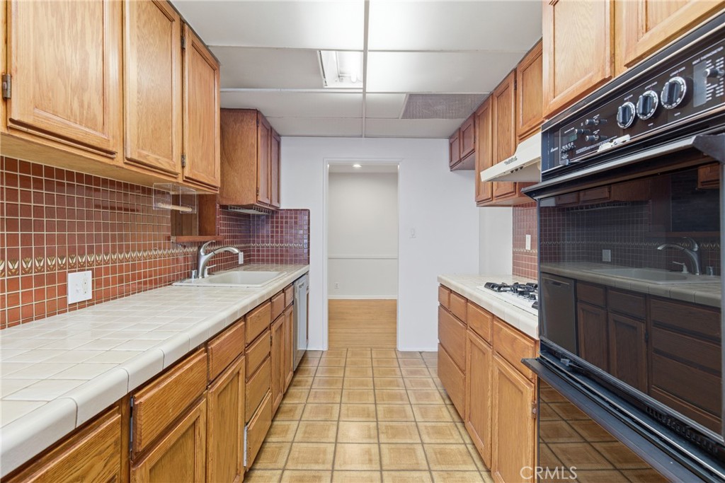 16753 Magnolia Boulevard Encino, CA 91436 - Photo 6 of 30 a kitchen with stainless steel appliances granite countertop a sink and cabinets