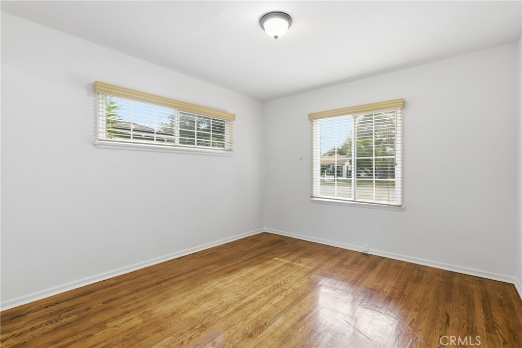 16753 Magnolia Boulevard Encino, CA 91436 - Photo 9 of 30 an empty room with wooden floor
