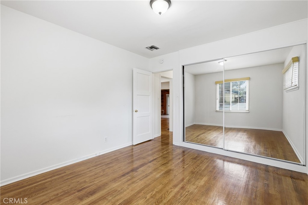 16753 Magnolia Boulevard Encino, CA 91436 - Photo 10 of 30 an empty room with wooden floor and windows
