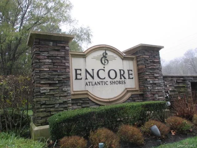 a sign that is sitting on a brick wall