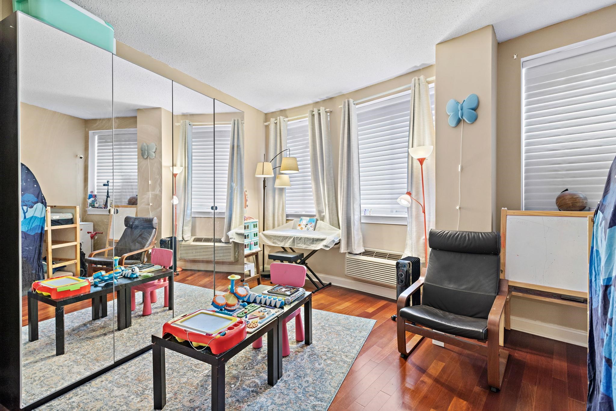 311 Washington Street, Unit 9C Jersey City, NJ 07302 - Photo 12 of 17 a living room with furniture and a window