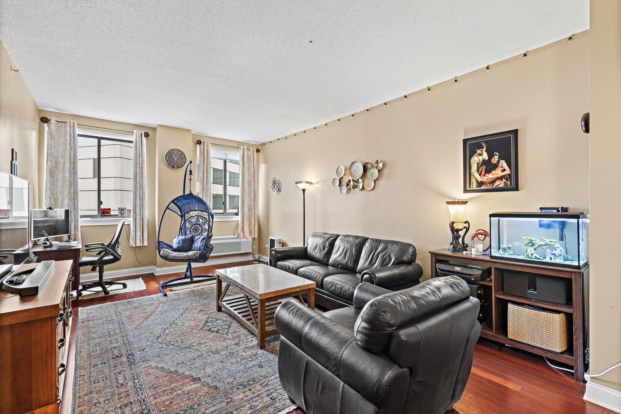 311 Washington Street, Unit 9C Jersey City, NJ 07302 - Photo 4 of 17 a living room with furniture and a large window