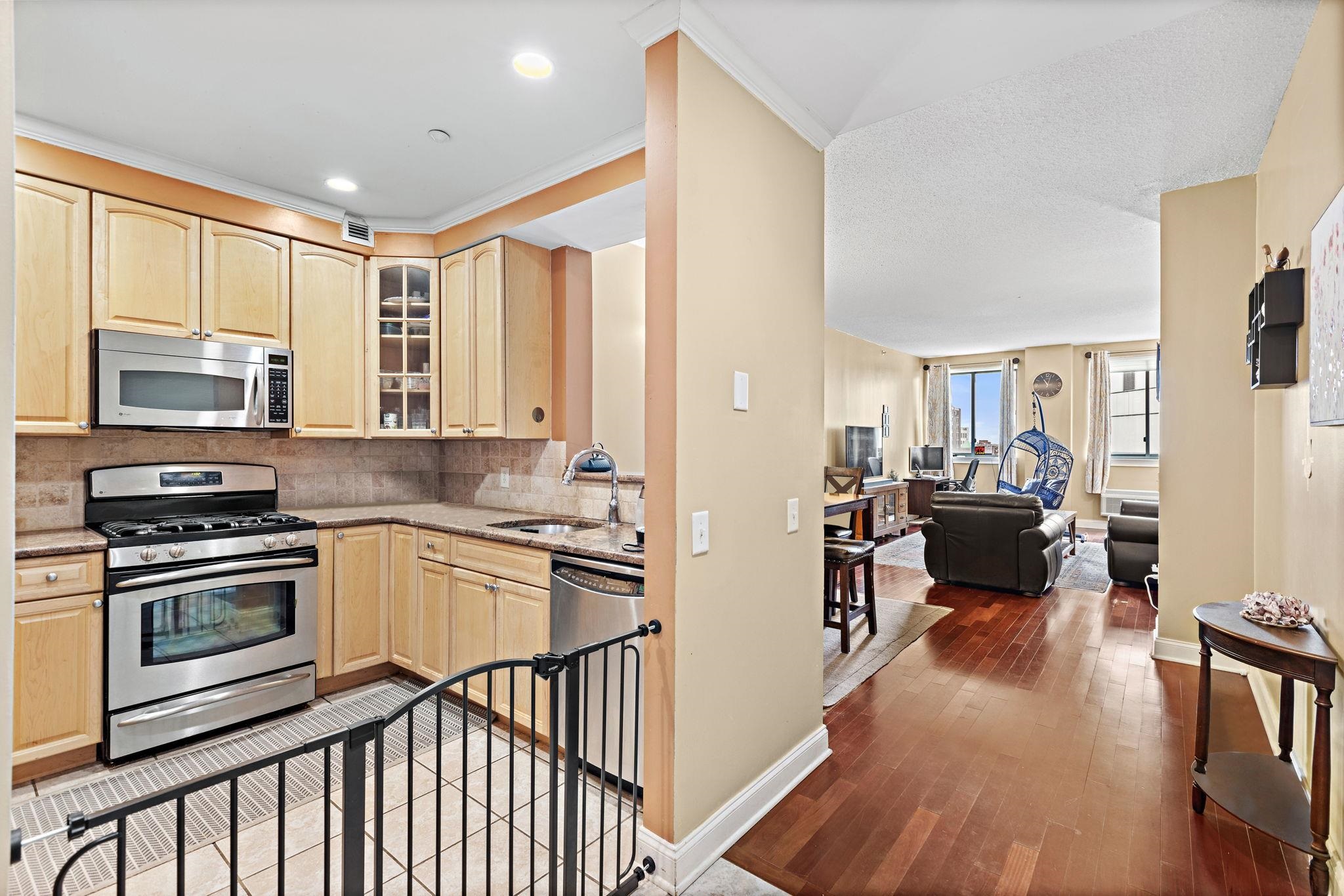 311 Washington Street, Unit 9C Jersey City, NJ 07302 - Photo 6 of 17 a kitchen with a stove a sink and a refrigerator
