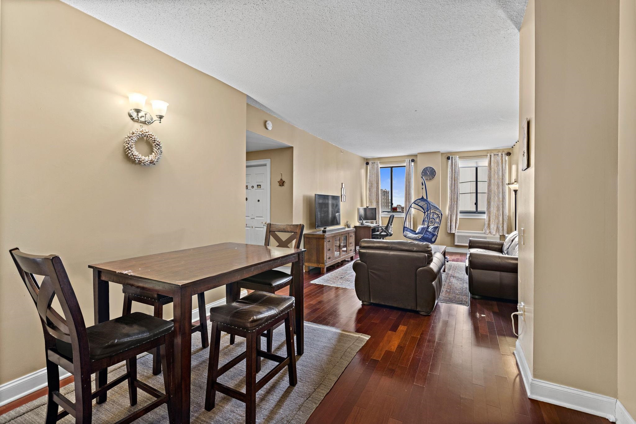311 Washington Street, Unit 9C Jersey City, NJ 07302 - Photo 7 of 17 a view of a dining room with furniture and wooden floor
