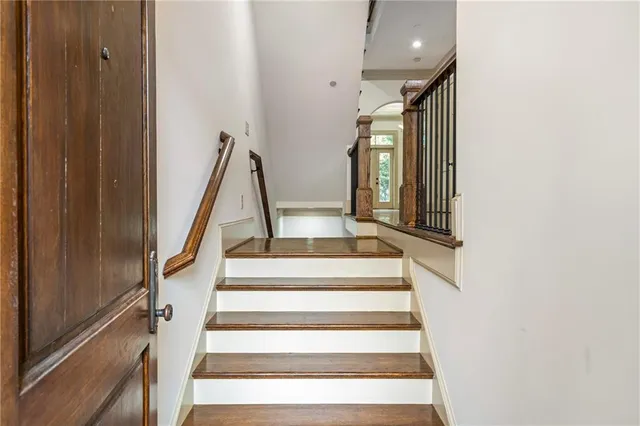 a view of staircase with white walls and a window
