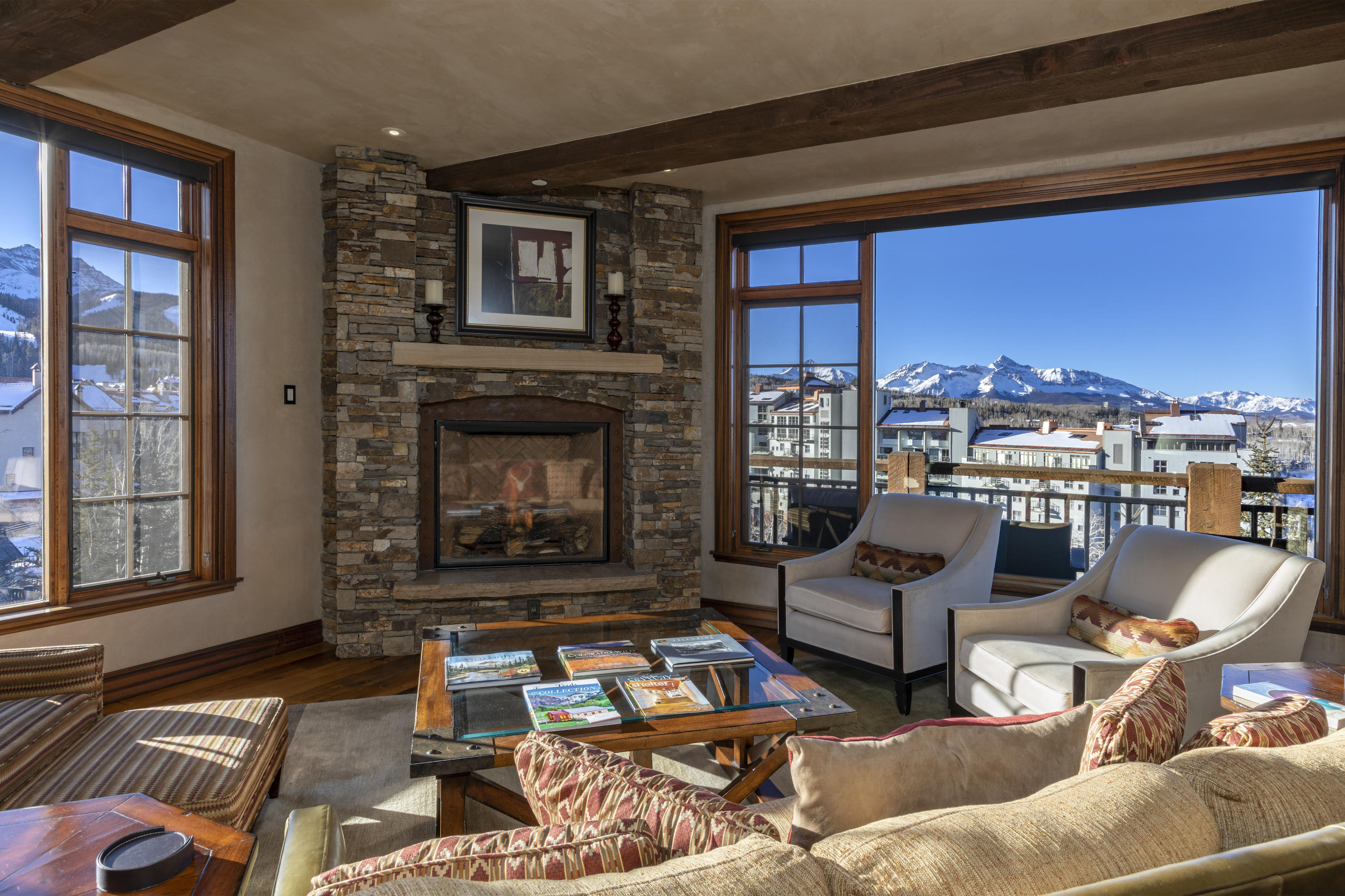 117 Sunny Ridge Place, Unit 128 Mountain Village, CO 81435 - Photo 1 of 41 a living room with furniture and a fireplace
