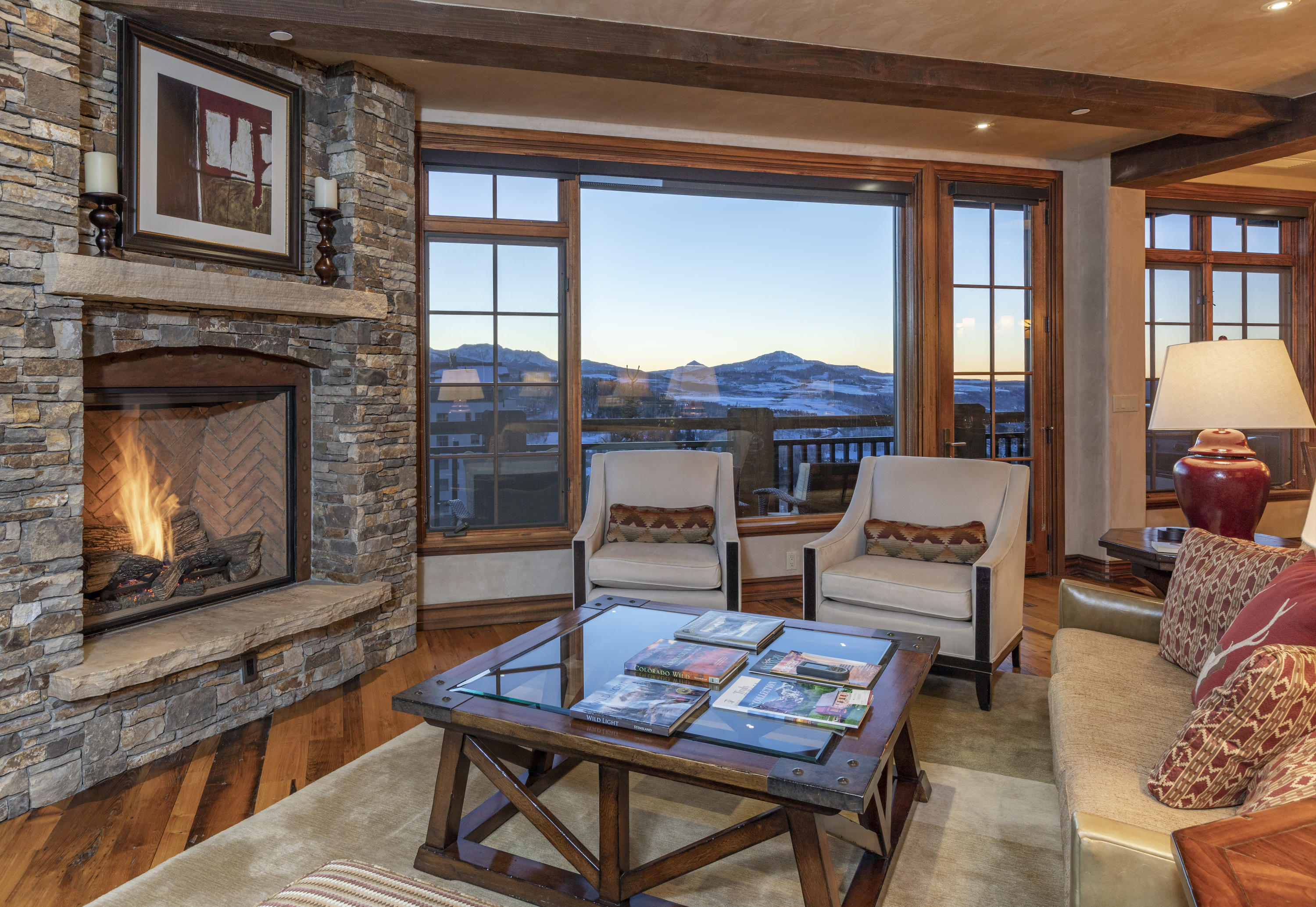 117 Sunny Ridge Place, Unit 128 Mountain Village, CO 81435 - Photo 4 of 41 a living room with furniture a window and a fireplace