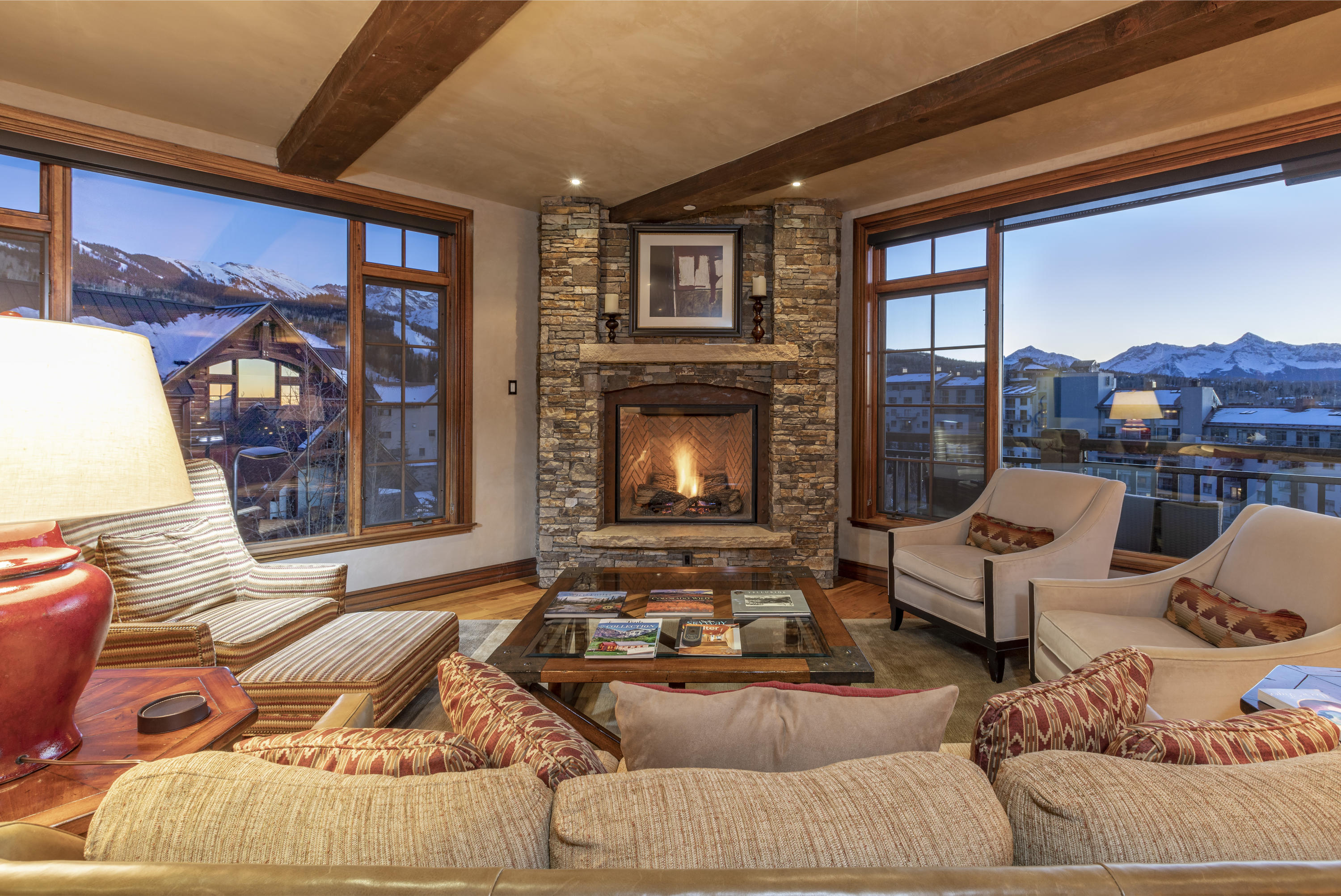 117 Sunny Ridge Place, Unit 128 Mountain Village, CO 81435 - Photo 5 of 41 a living room with furniture fireplace and a large window
