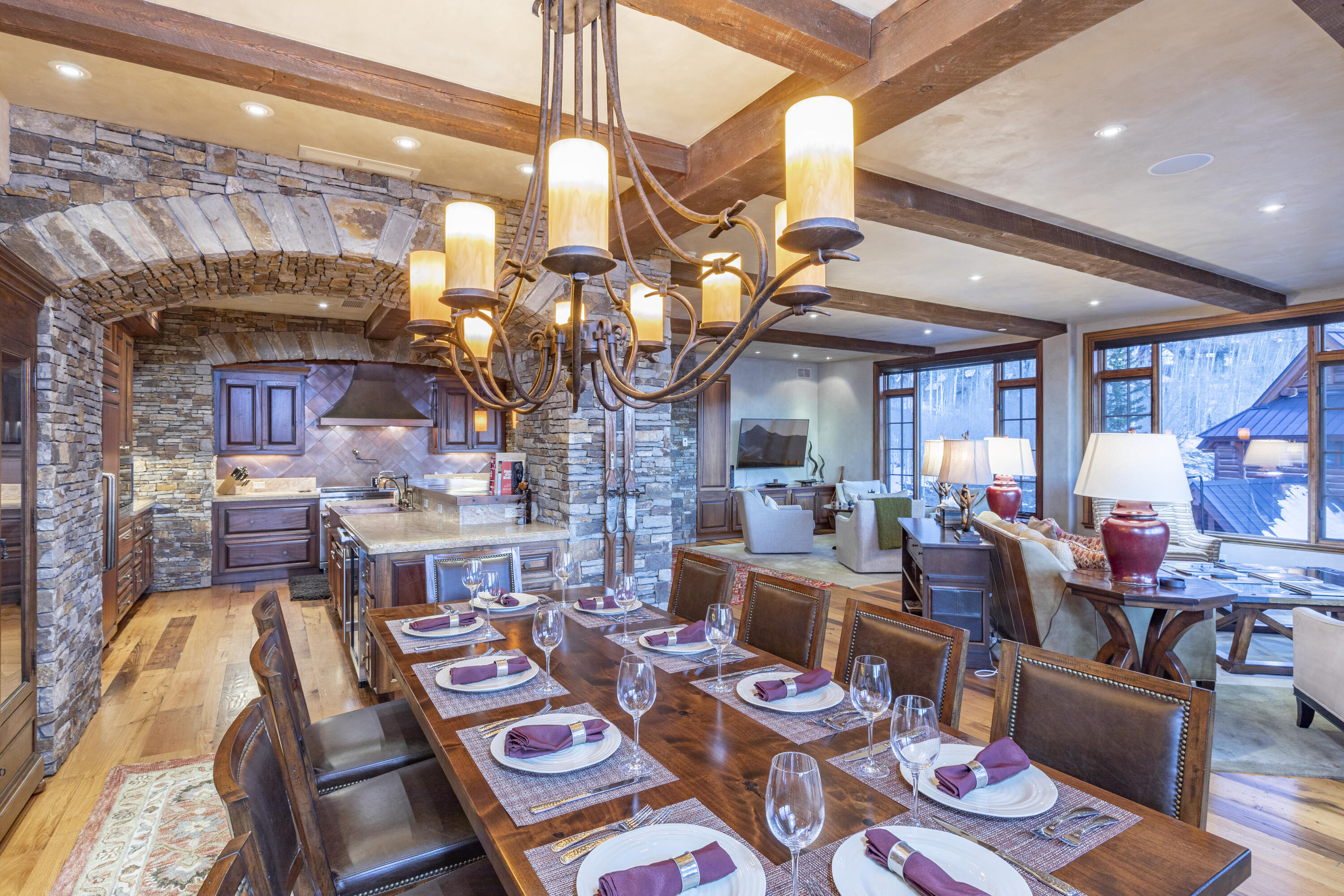 117 Sunny Ridge Place, Unit 128 Mountain Village, CO 81435 - Photo 9 of 41 a living room with lots of furniture and a chandelier