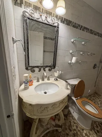 a bathroom with a sink toilet and shower