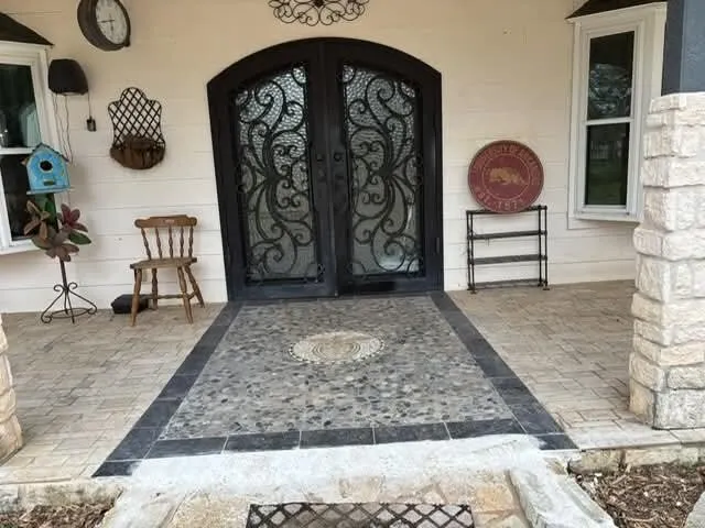 a view of a porch with chairs and backyard of the house