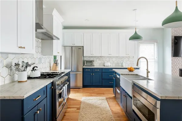 a kitchen with stainless steel appliances granite countertop a sink stove and refrigerator