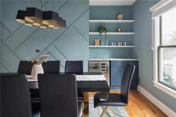 a kitchen with a sink dishwasher and a stove with wooden floor