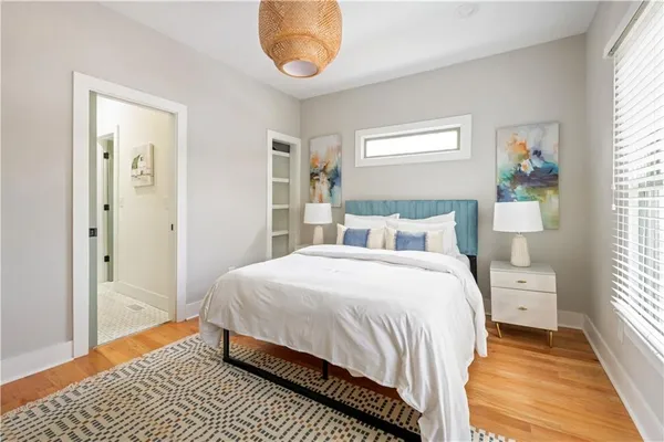 a bedroom with a bed and a painting on the wall