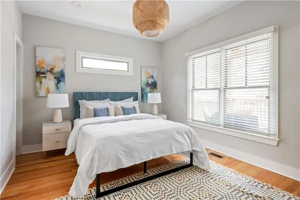 a bedroom with bed and wooden floor