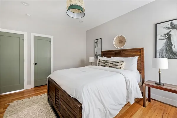 a bedroom with a bed and a lamp on table