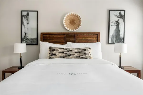 a large bed sitting in a bedroom next to a window