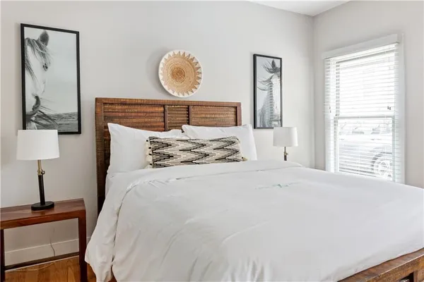 a bedroom with a bed and a potted plant