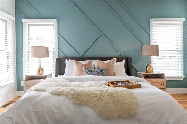 a bedroom with a bed and a mirror