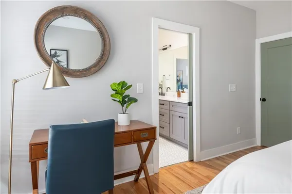 a bathroom with a granite countertop sink a toilet and a mirror