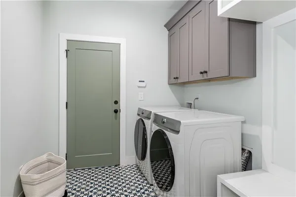 a front view of a house with a yard and trees