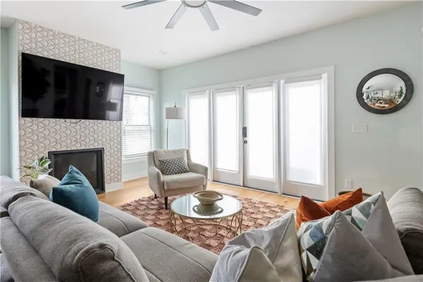 a living room with furniture a fireplace and a flat screen tv