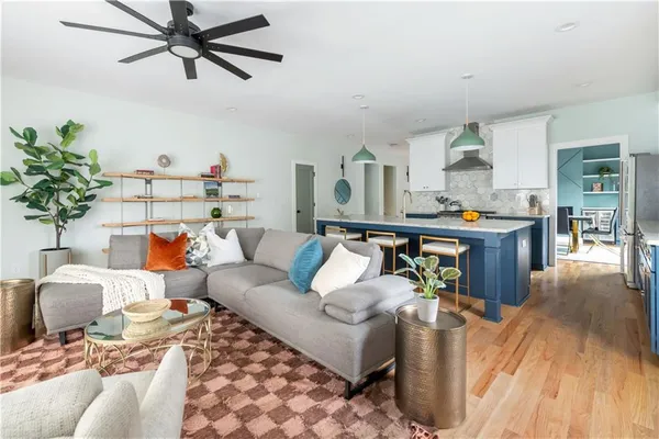 a living room with furniture and a wooden floor