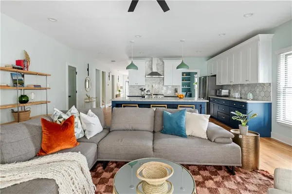 a living room with furniture and a kitchen